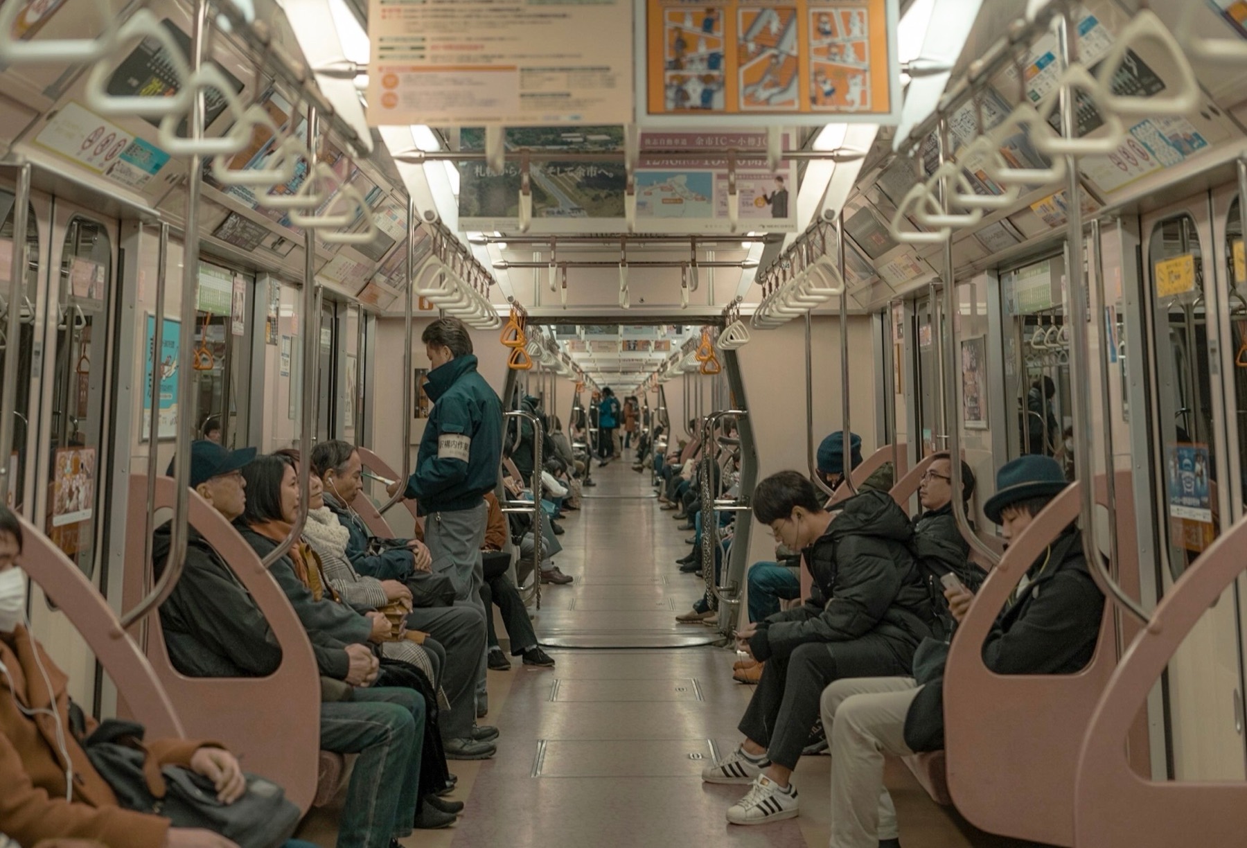 Commuters on a quiet Tokyo subway carriage
