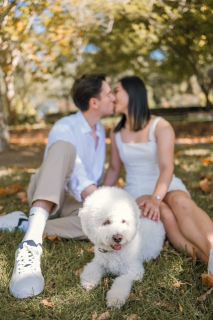 The couple kissing in the background while Marlo lies in the grass in front