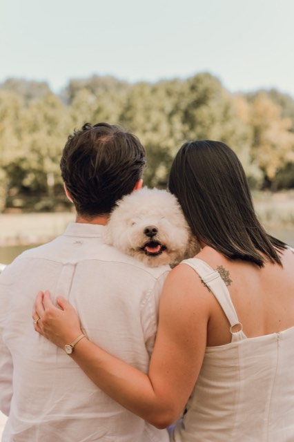 The couple seen from behind with their arms around each other, Marlo peeking over Damon's shoulder