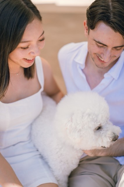 Close-up of Damon and Christina smiling down at Marlo in her lap